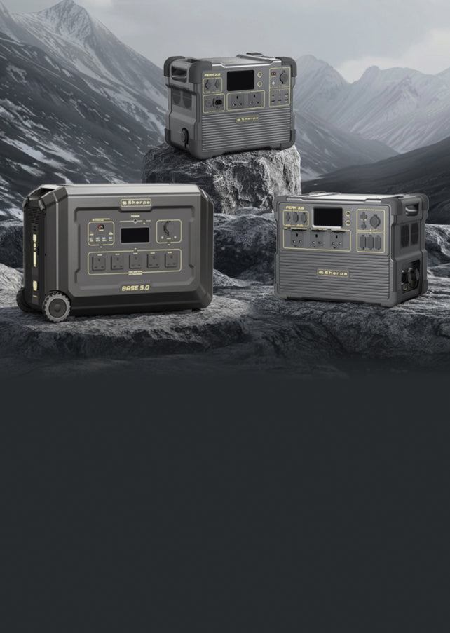 Three portable power stations on a rocky surface with mountainous background